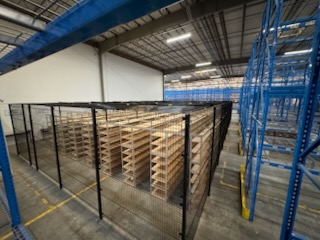 Security cage interior with floor-to-ceiling archival shelving